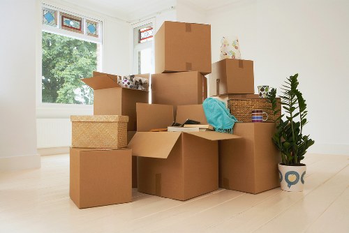 Professional movers transporting furniture from a Harrow property