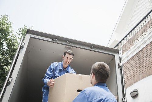 Careful loading of a piano into a removal vehicle for transport across Harrow