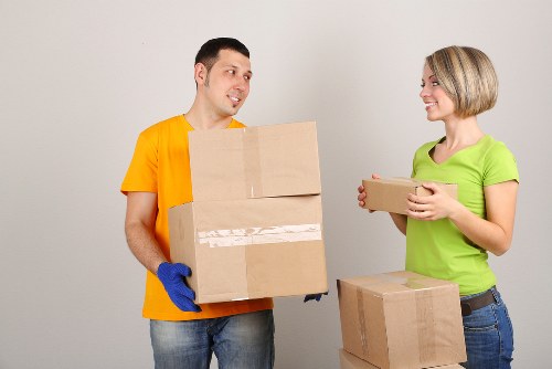 Professional removals team handling stairs in a Harrow flat block